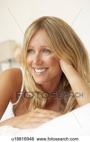 Young Woman Relaxing On Bed View Large Photo Image Stock Photo - Young Woman Relaxing On Bed. Fotosearch