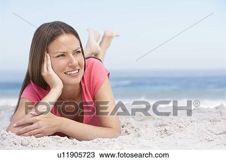 Young Woman Relaxing On Sandy Beach View Large Photo Image Stock Image - Young Woman Relaxing On Sandy Beach. Fotosearch