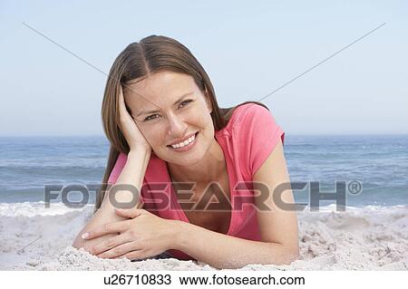 Young Woman Relaxing On Sandy Beach View Large Photo Image Stock Image - Young Woman Relaxing On Sandy Beach. Fotosearch