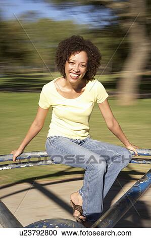 Young Woman Riding On Roundabout In Park View Large Photo Image Stock Image - Young Woman Riding On Roundabout In Park. Fotosearch