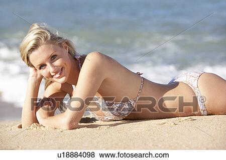 Young Woman Sunbathing On Beach View Large Photo Image Stock Photo - Young Woman Sunbathing On Beach . Fotosearch