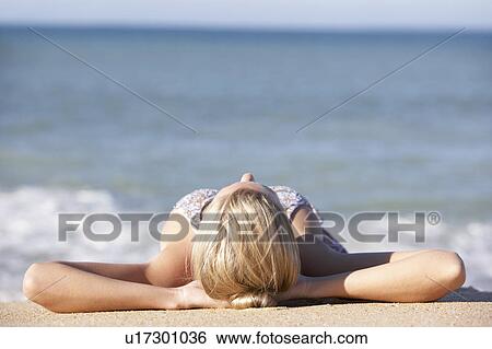 Young Woman Sunbathing On Beach View Large Photo Image Stock Photograph - Young Woman Sunbathing On Beach . Fotosearch