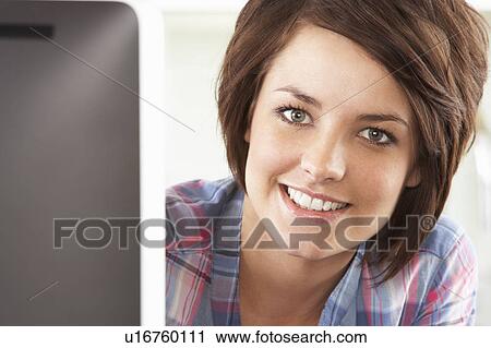 Young Woman Using Computer In Modern Kitchen View Large Photo Image Stock Image - Young Woman Using Computer In Modern Kitchen . Fotosearch