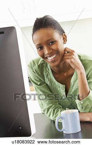 Young Woman Using Computer In Modern Kitchen View Large Photo Image Stock Image - Young Woman Using Computer In Modern Kitchen . Fotosearch