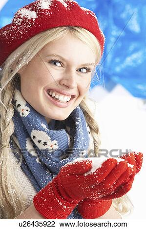 Young Woman Wearing Warm Winter Clothes And Hat Holding Snow In Studio View Large Photo Image Stock Image - Young Woman Wearing Warm Winter Clothes And Hat Holding Snow In Studio. Fotosearch