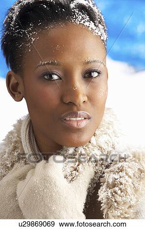 Stock Photo - Young Woman Wearing Warm Winter Clothes In Studio. Fotosearch