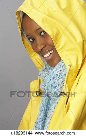 Young Woman Wearing Yellow Raincoat In Studio View Large Photo Image Picture - Young Woman Wearing Yellow Raincoat In Studio. Fotosearch