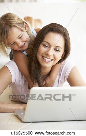 Young woman with girl using laptop computer View Large Photo Image Stock Image - Young woman with girl using laptop computer. Fotosearch