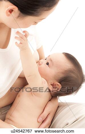 Stock Photo - Baby Boy Reaching Mother's Face. Fotosearch
