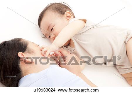 Baby Boy Touching Mother's Face View Large Photo Image Picture - Baby Boy Touching Mother's Face. Fotosearch