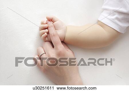 Baby holding mother's finger View Large Photo Image Stock Image - Baby holding mother's finger. Fotosearch