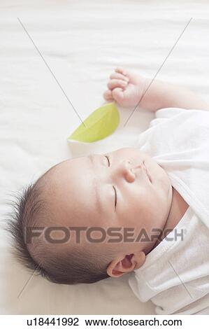 Baby lying down View Large Photo Image Stock Image - Baby lying down. Fotosearch