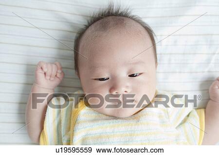 Baby lying down View Large Photo Image Stock Photo - Baby lying down. Fotosearch