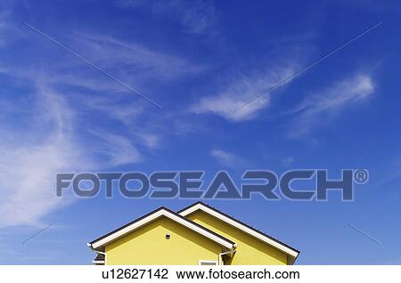 Stock Image - Blue Sky Over House. Fotosearch