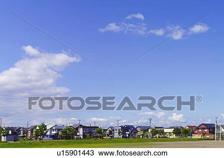 Stock Image - Blue Sky Over Residential Area. Fotosearch