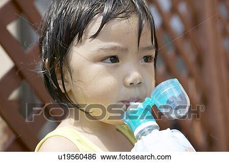 Stock Photograph - Boy drinking water, Chiba Prefecture, Honshu, Japan. Fotosearch
