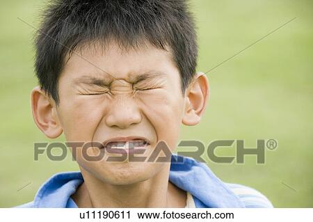 Stock Image - Boy making a face, Chiba Prefecture, Honshu, Japan. Fotosearch