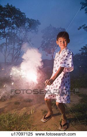 Stock Photography - Boy playing with firework, Chiba Prefecture, Honshu, Japan. Fotosearch