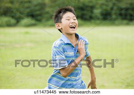 Stock Photography - Boy running, Chiba Prefecture, Honshu, Japan. Fotosearch