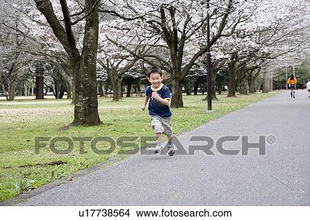 Boy Running in Park View Large Photo Image Picture - Boy Running in Park. Fotosearch