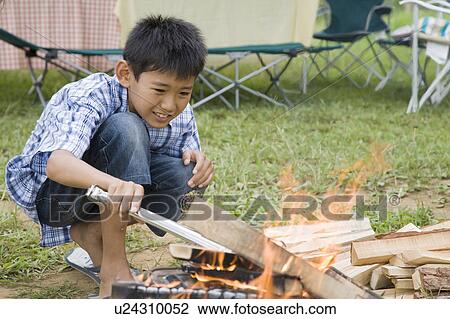Boy starting a campfire, Chiba Prefecture, Honshu, Japan View Large Photo Image Stock Image - Boy starting a campfire, Chiba Prefecture, Honshu, Japan. Fotosearch