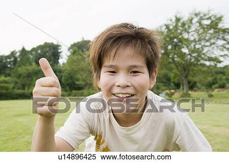 Stock Photography - Boy with thumbs up, Chiba Prefecture, Honshu, Japan. Fotosearch