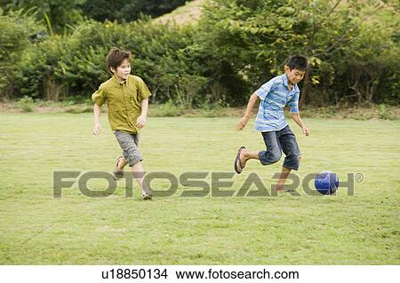 Boys playing soccer, Chiba Prefecture, Honshu, Japan View Large Photo Image Picture - Boys playing soccer, Chiba Prefecture, Honshu, Japan. Fotosearch