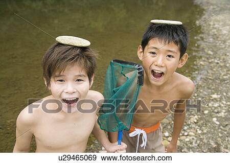 Boys Standing with mouth open and rocks on their head, Chiba Prefecture, Honshu, Japan View Large Photo Image Stock Photo - Boys Standing with mouth open and rocks on their head, Chiba Prefecture, Honshu, Japan. Fotosearch