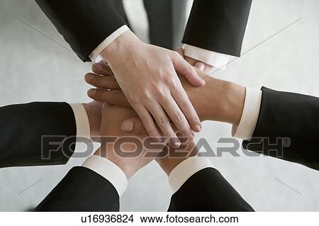Business people stacking hands View Large Photo Image Picture - Business people stacking hands. Fotosearch