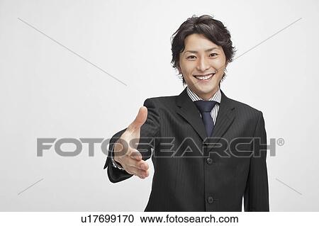 Stock Image - Businessman about to shake hands. Fotosearch
