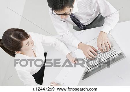 Businessman and businesswoman in a meeting View Large Photo Image Stock Photo - Businessman and businesswoman in a meeting. Fotosearch