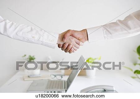 Businessman and businesswoman shaking hands View Large Photo Image Stock Photograph - Businessman and businesswoman shaking hands. Fotosearch