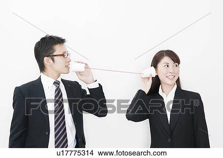 Businessman and businesswoman using tin can phone View Large Photo Image Picture - Businessman and businesswoman using tin can phone. Fotosearch