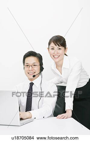 Picture - Businessman and woman looking at camera. Fotosearch