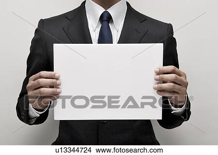 Businessman holding blank cardboard View Large Photo Image Picture - Businessman holding blank cardboard. Fotosearch