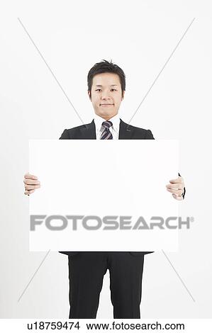 Picture - Businessman holding blank cardboard. Fotosearch