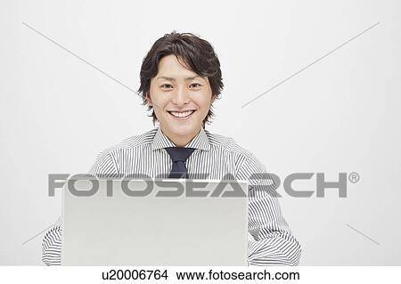 Businessman using a laptop View Large Photo Image Picture - Businessman using a laptop. Fotosearch