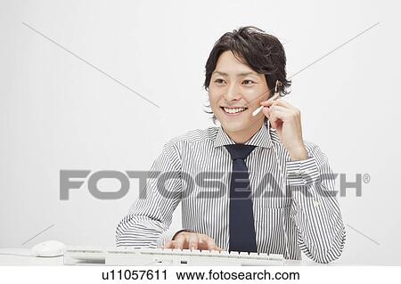 Businessman wearing a headset View Large Photo Image Stock Image - Businessman wearing a headset. Fotosearch
