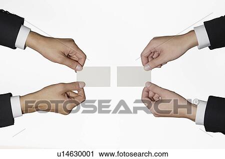Stock Image - Businessmen exchanging business cards. Fotosearch