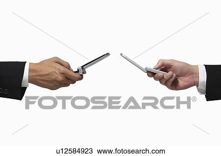 Stock Image - Businessmen holding cell phones. Fotosearch