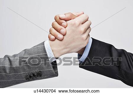 Picture - Businessmen shaking hands. Fotosearch