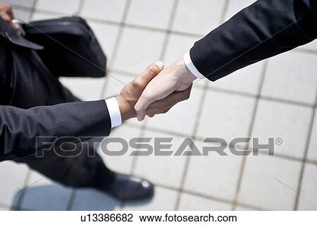 Stock Image - Businessmen shaking hands. Fotosearch