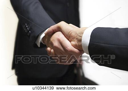 Stock Photo - Businessmen shaking hands. Fotosearch