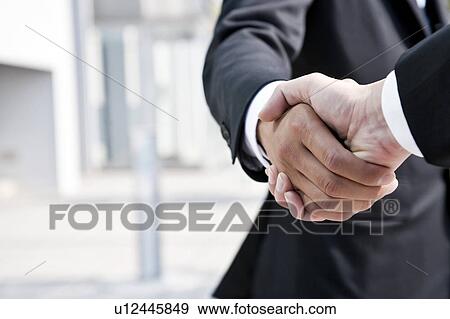 Stock Photo - Businessmen shaking hands. Fotosearch
