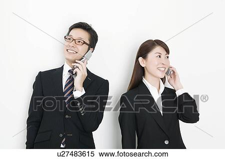 Stock Photography - Businesspeople on cell phone. Fotosearch