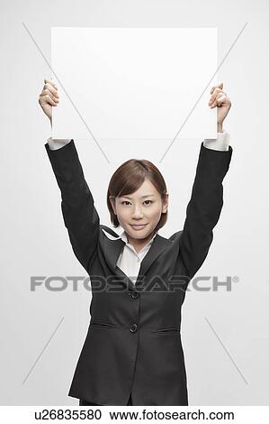 Businesswoman holding blank cardboard View Large Photo Image Stock Image - Businesswoman holding blank cardboard. Fotosearch
