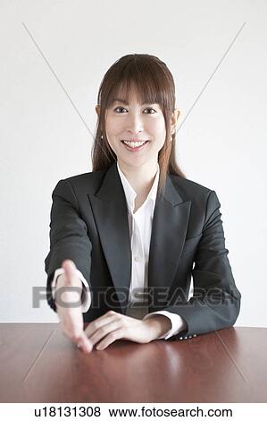 Stock Photo - Businesswoman with her hand out. Fotosearch