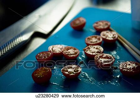 Stock Photo - Cherry tomatoes cut on half. Fotosearch