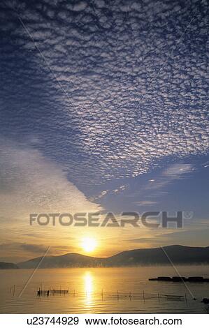 Stock Photo - Cirrocumulus Clouds over Lake. Fotosearch