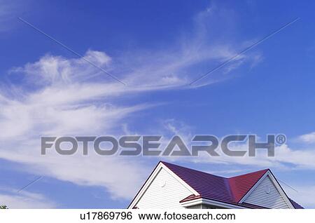 Stock Photograph - Cirrus Clouds Over House. Fotosearch